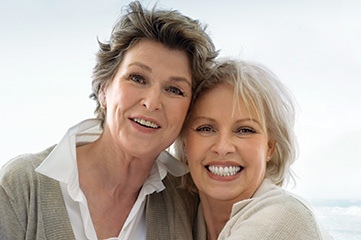 Photo of two smiling women. Link to Life Stage Gift Planner Ages 60-70 Situations.